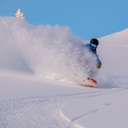 A person shredding on a snowboard at Sunday River.