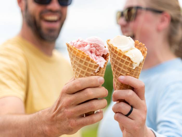 A man and a woman pose with their ice creams at Sunday River.