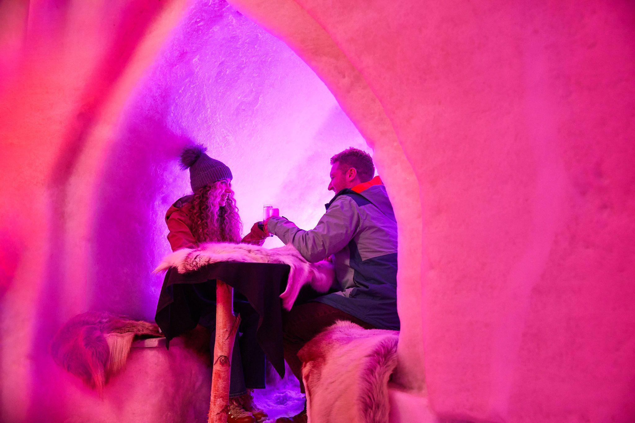 A man and a woman cheers over drinks at The Igloo at Sunday River.
