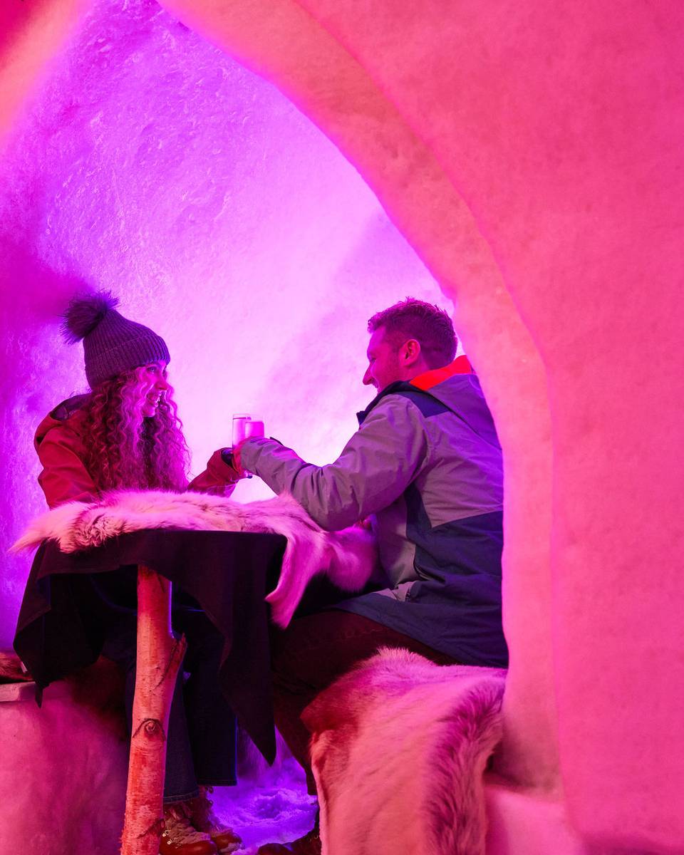 A man and a woman cheers over drinks at The Igloo at Sunday River.