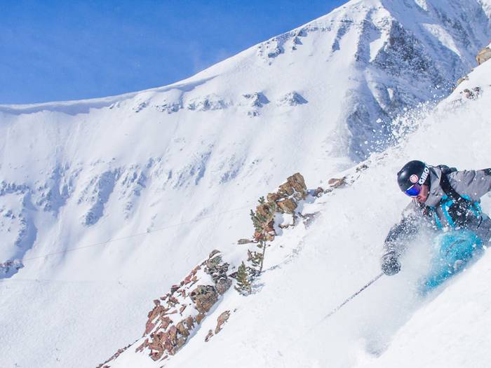 A skier shredding down a trail at Big Sky.
