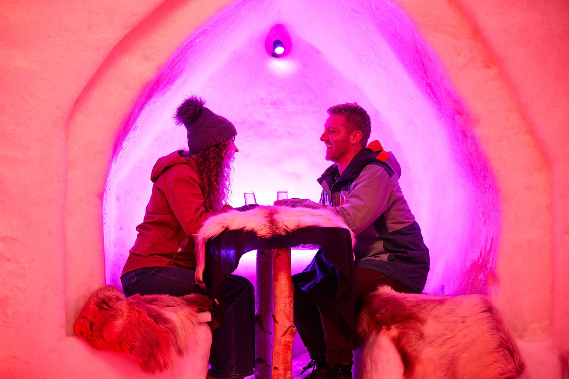 People sitting in an ice pod at The Iglu at Sunday River.