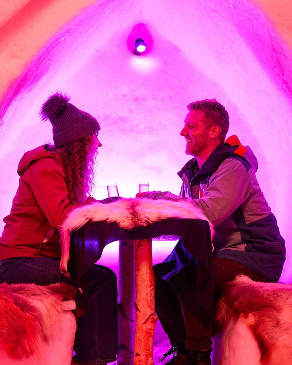 Two people sitting and enjoying a drink in The Igloo.