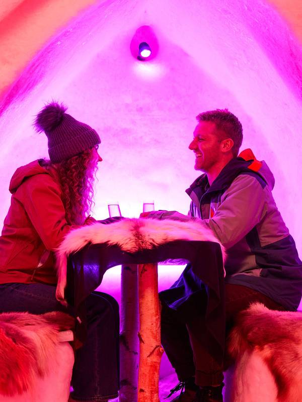 A couple enjoying a private booth at the Igloo