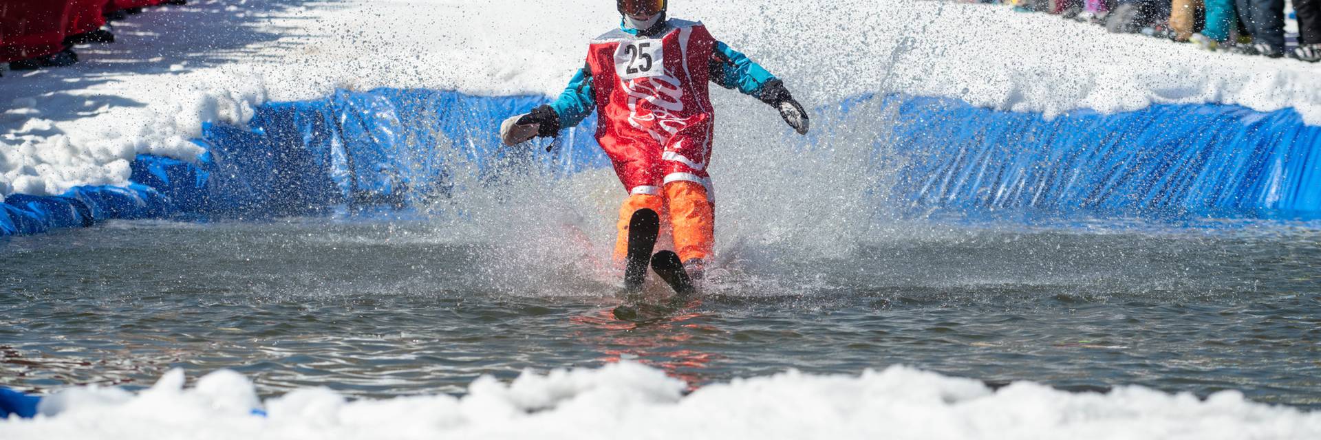Skier is a Coca Cola costume on the pond skim.