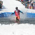 Skier is a Coca Cola costume on the pond skim.