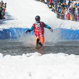 Skier is a Coca Cola costume on the pond skim.