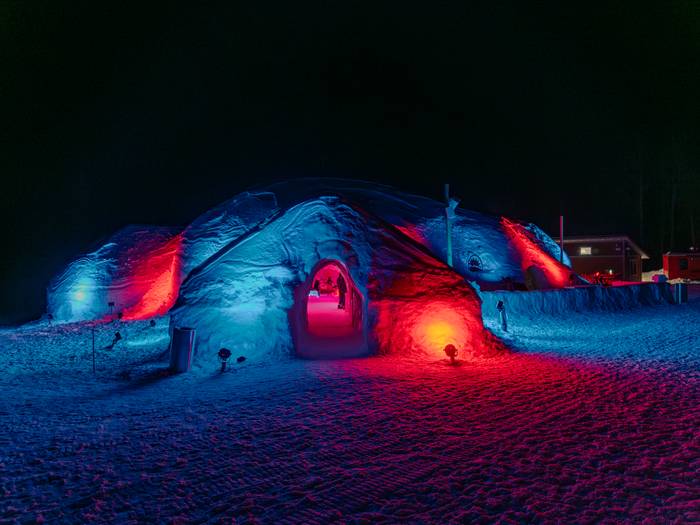 The Igloo at Sunday River, with exterior lights, at night.