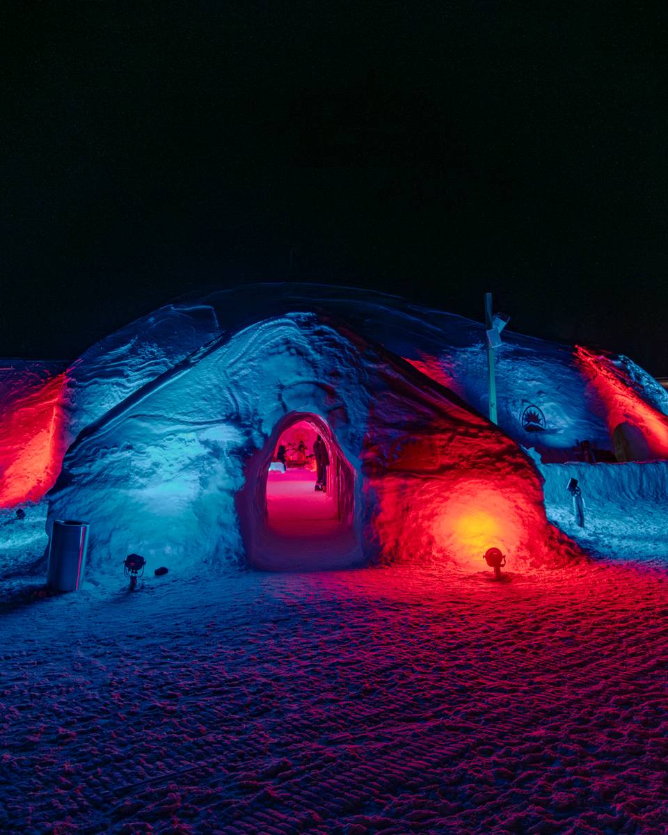 The Igloo at Sunday River, with exterior lights, at night.
