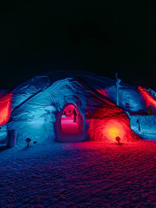 The Igloo at Sunday River with colorful exterior lights at night.