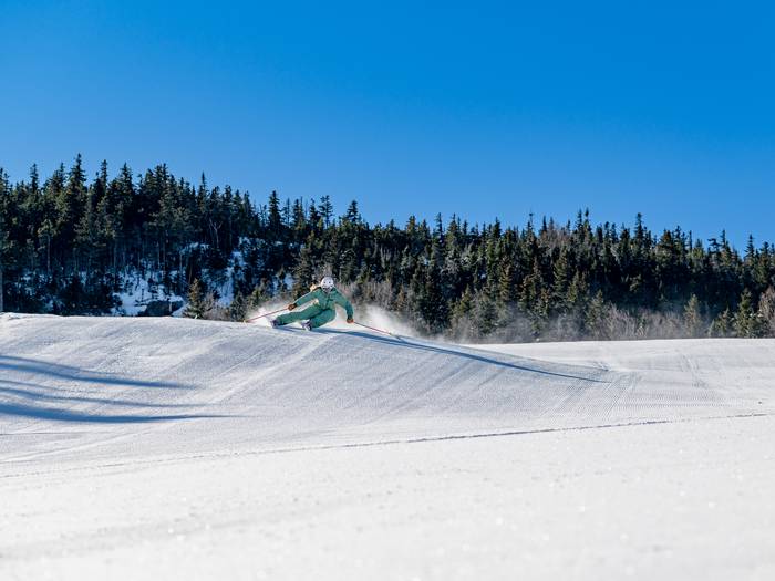 Skier on Northern Lights carving a turn.