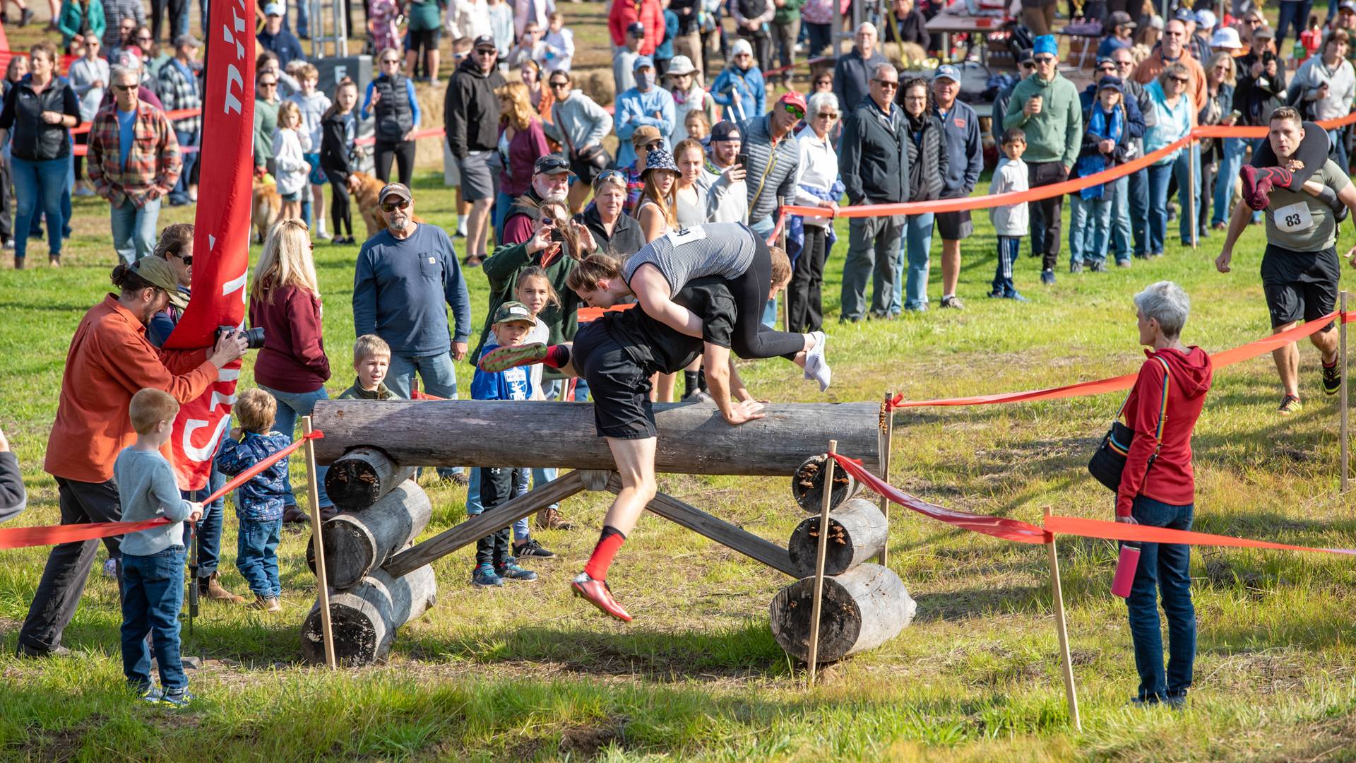 A man jumping over a lob obstacle during the North American Wife Carrying Championship at Sunday River.