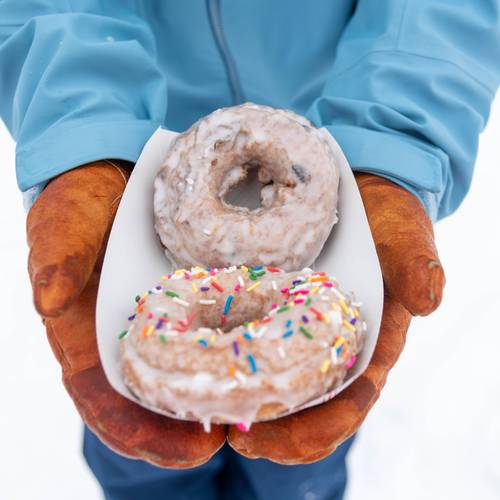A person holding a tray of donuts at Sunday River.