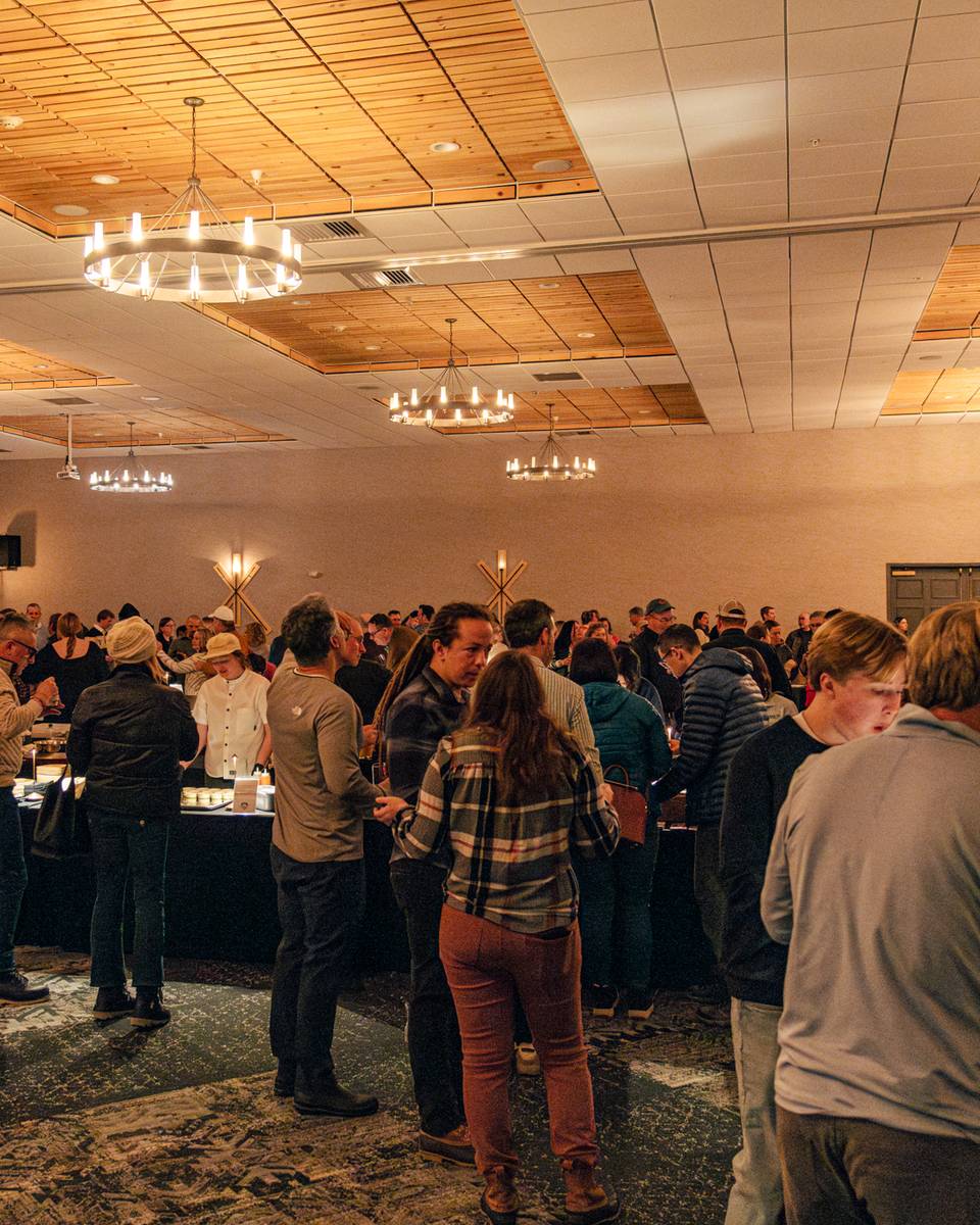 People standing and enjoying food at the Chef Summit at Sunday River.