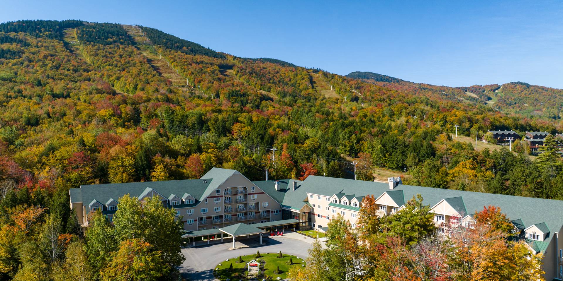 The outside grand entrance to the Grand Summit Hotel at Sunday River Resort in the summer.