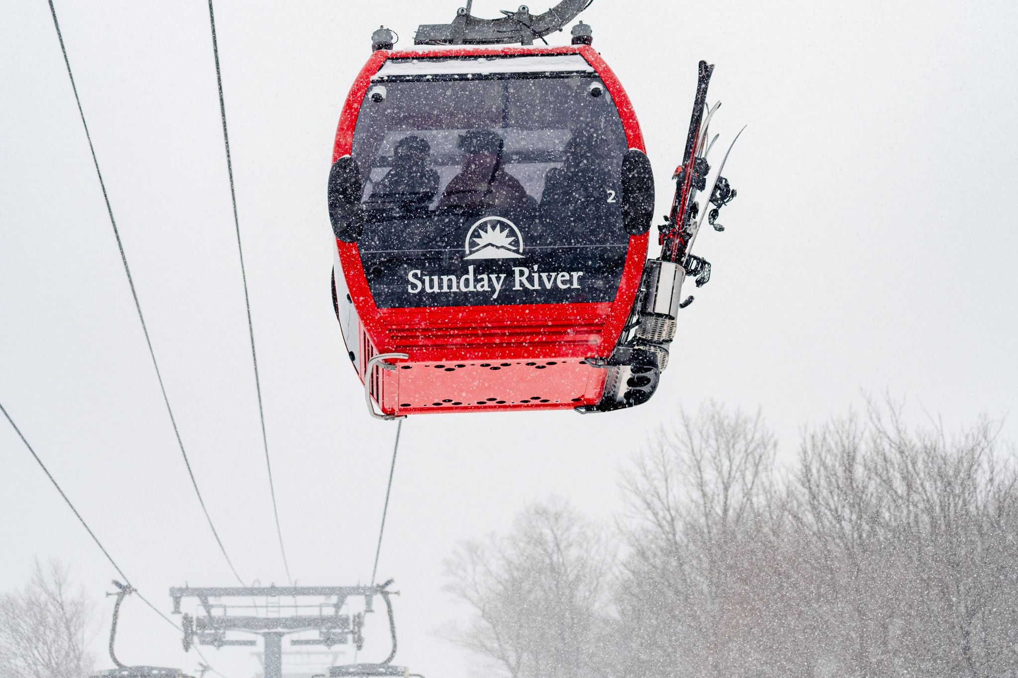 The Chondola at Sunday River with red cabin and Sunday River logo.