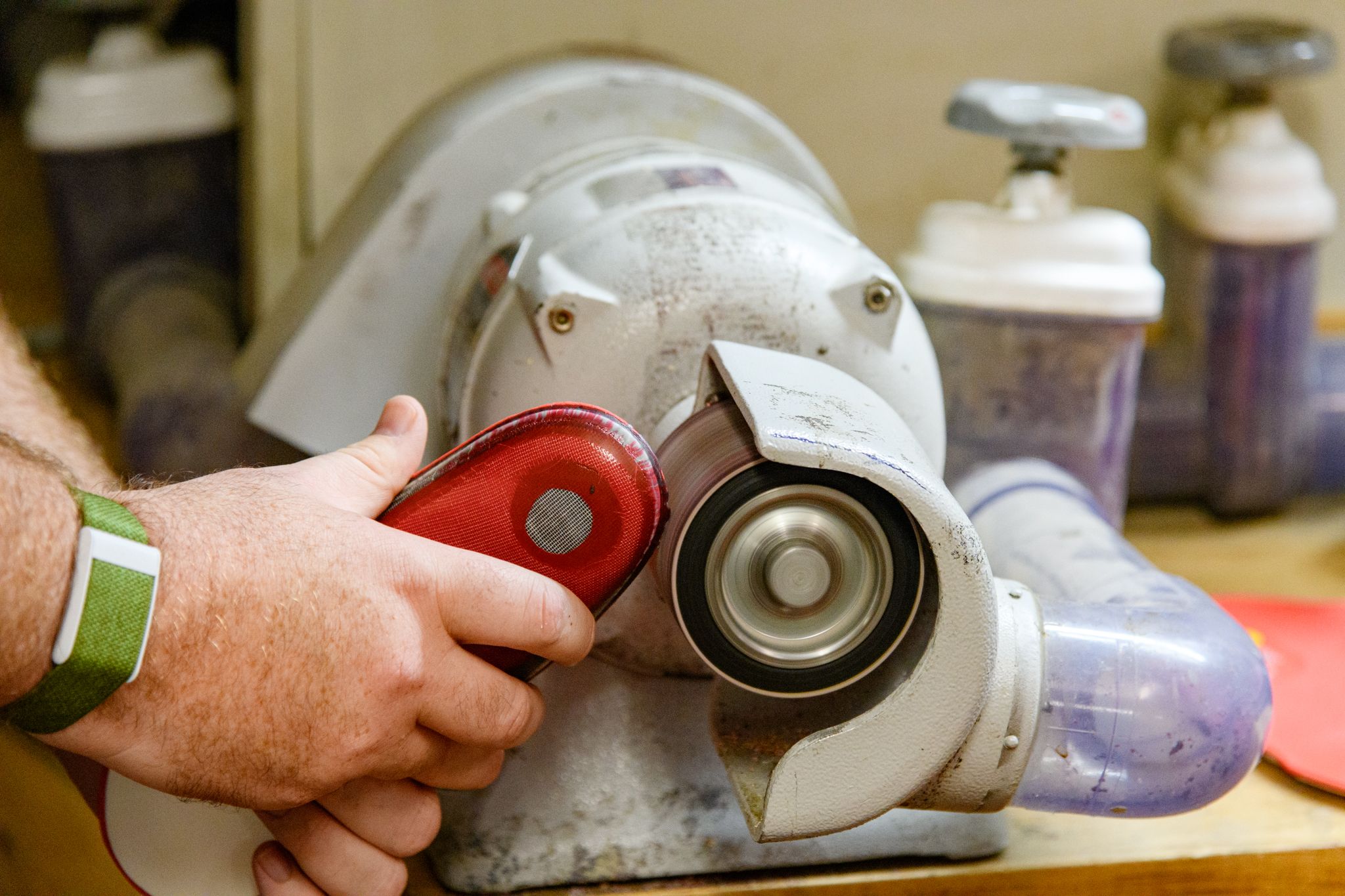 Shaping the insoles for the custom foot beds.