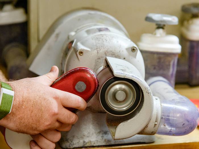 Shaping the insoles for the custom foot beds.
