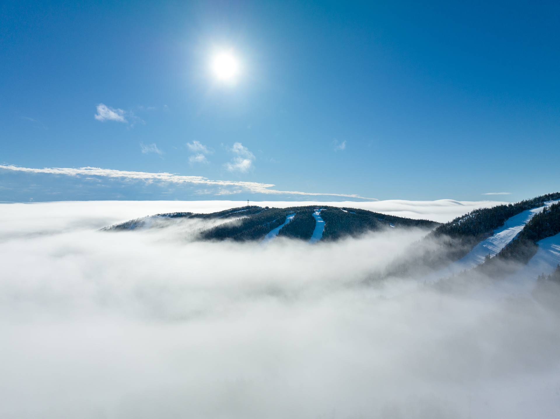 Low hanging clouds over the peaks at Sunday River in the winter.