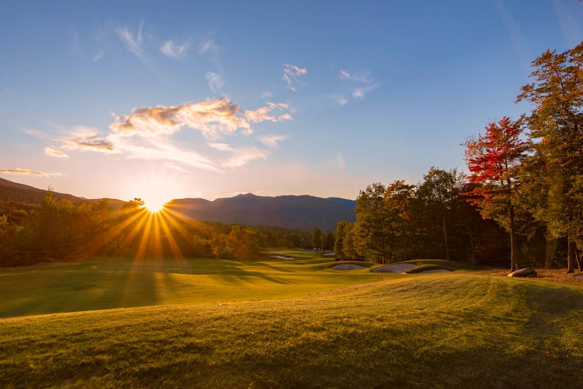 The sun setting at one of the holes, in the fall, at the Sunday River Golf Club.