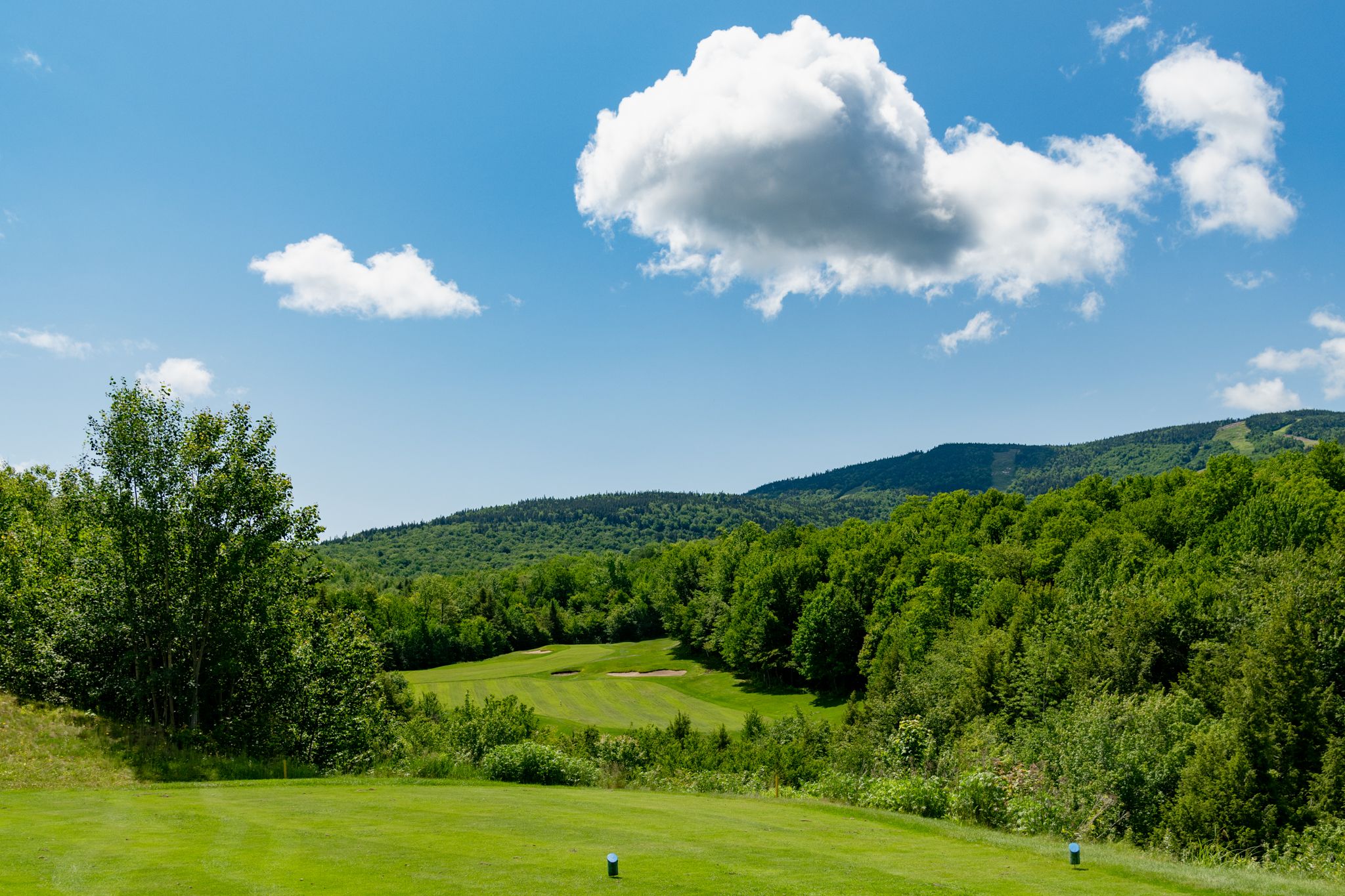 The sun setting along a green at the Sunday River Golf Club.