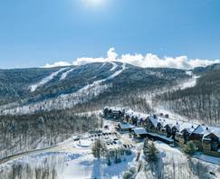 The Jordan Hotel in snow with Chairlift at Sunday River, Maine