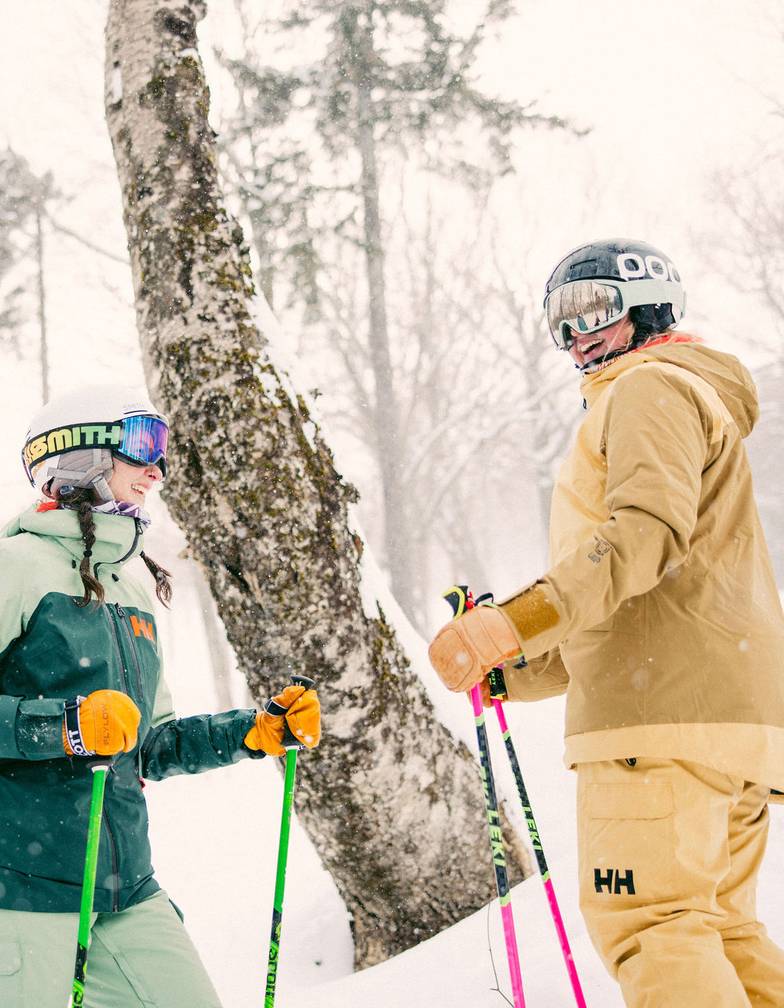 Two skiers talking and laughing at Sunday River