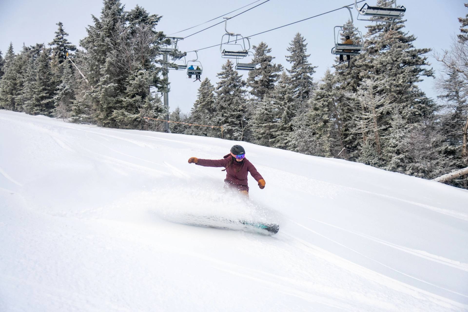 A person snowboarding at Sunday River.