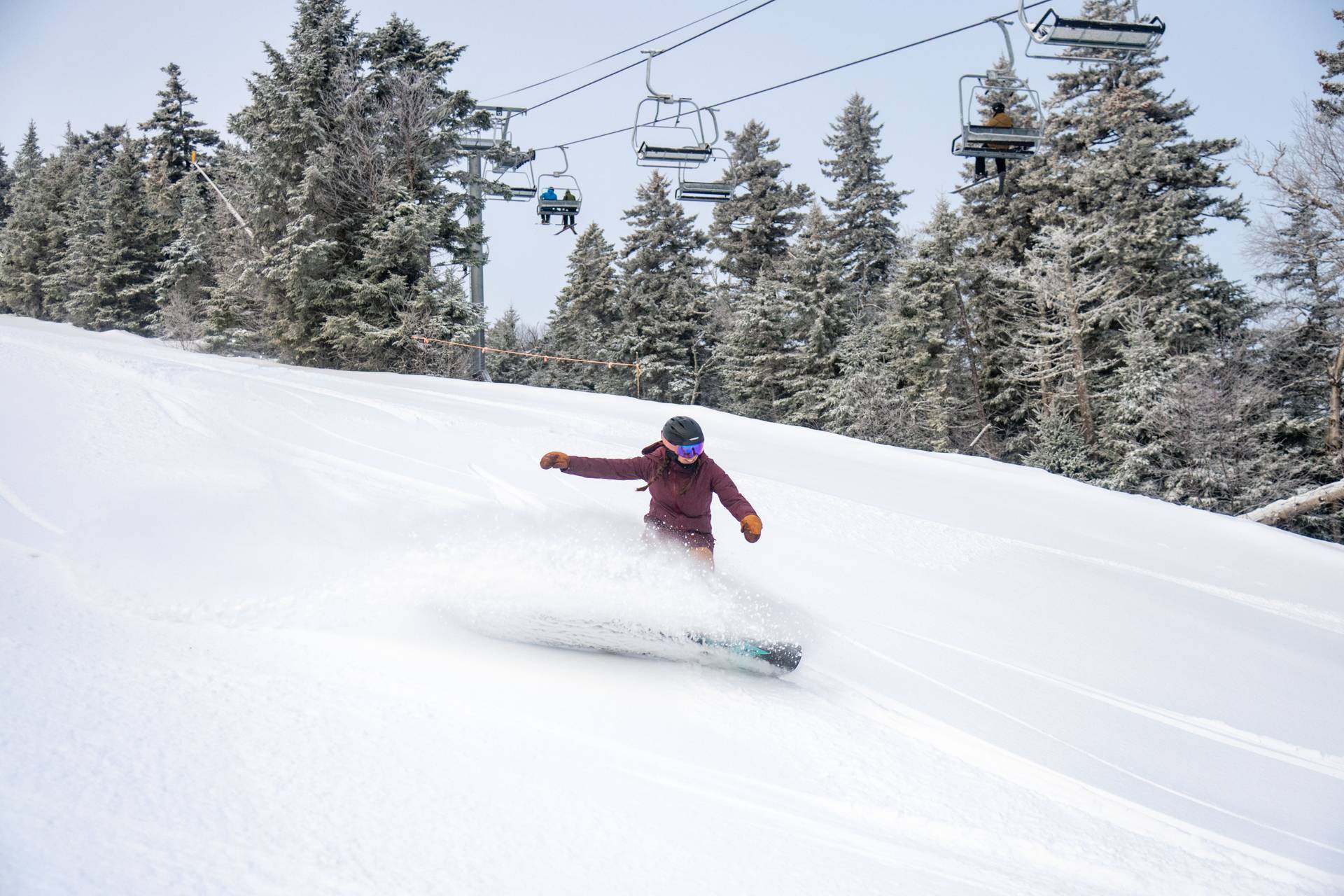 A person snowboarding in fresh snow at Sunday River.