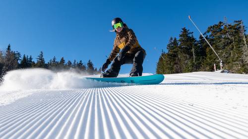 A person snowboarding at Sunday River.