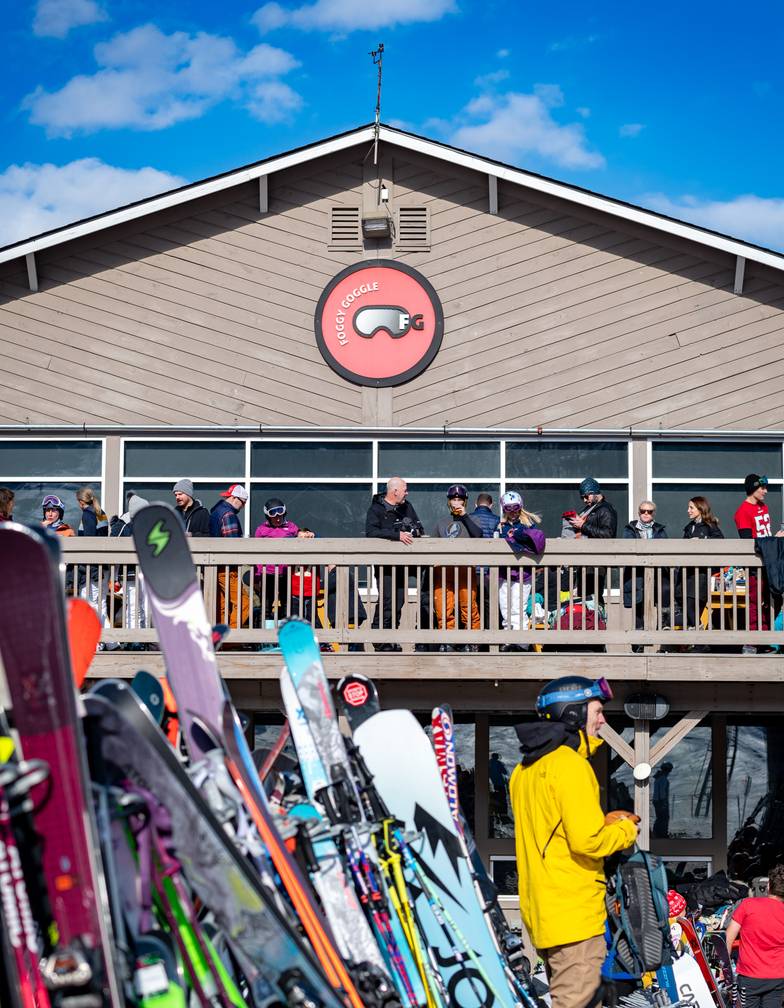 Skies and snowboards lined up outside the Foggy Goggle at Sunday River