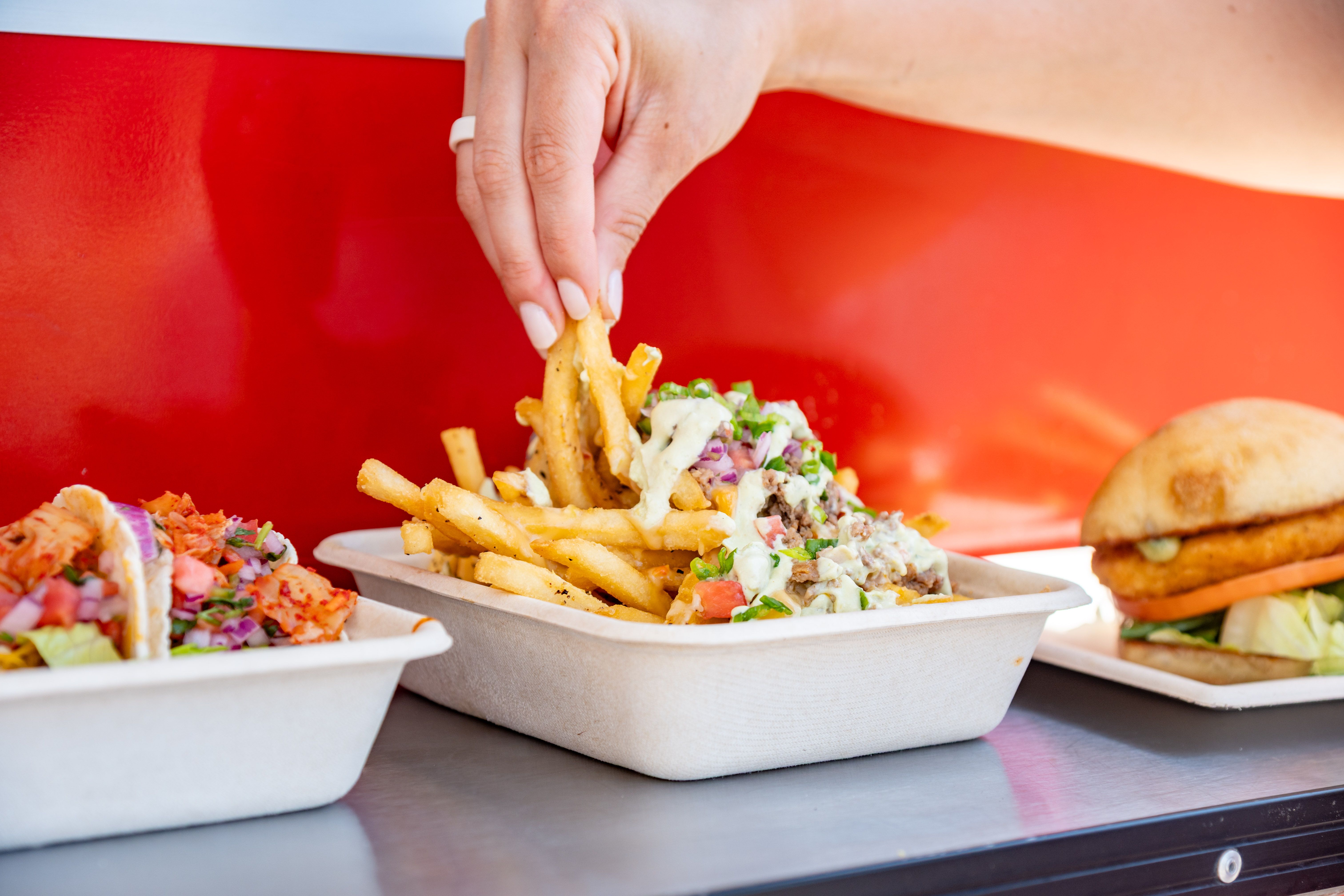 A person pulling some cheese fries at Sunny's.