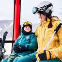 A little boy and his mother sitting in the Chondola at Sunday River.