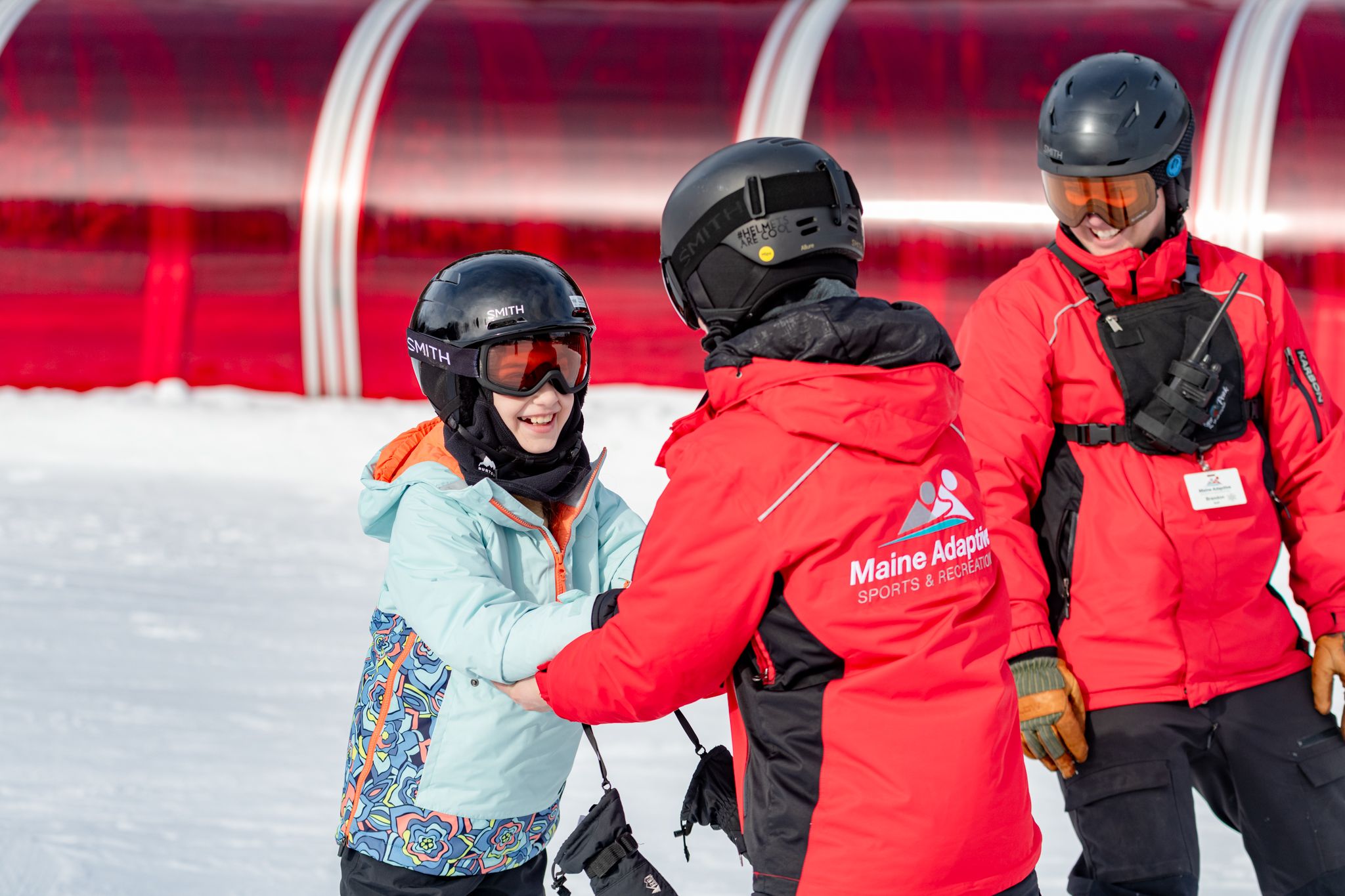Adaptive coaches with Maine Adaptive helping a young skier at Sunday River.