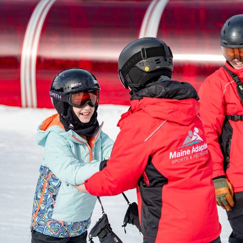Adaptive coaches with Maine Adaptive helping a young skier at Sunday River.