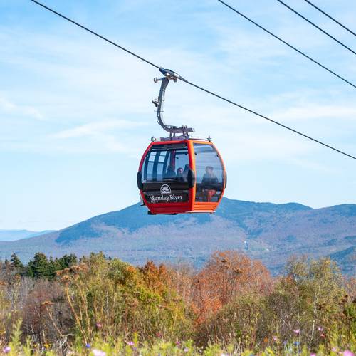People riding in the a Chondola cabin at Sunday River.