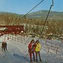 People using a t-bar at Sunday River in the late 1950s.
