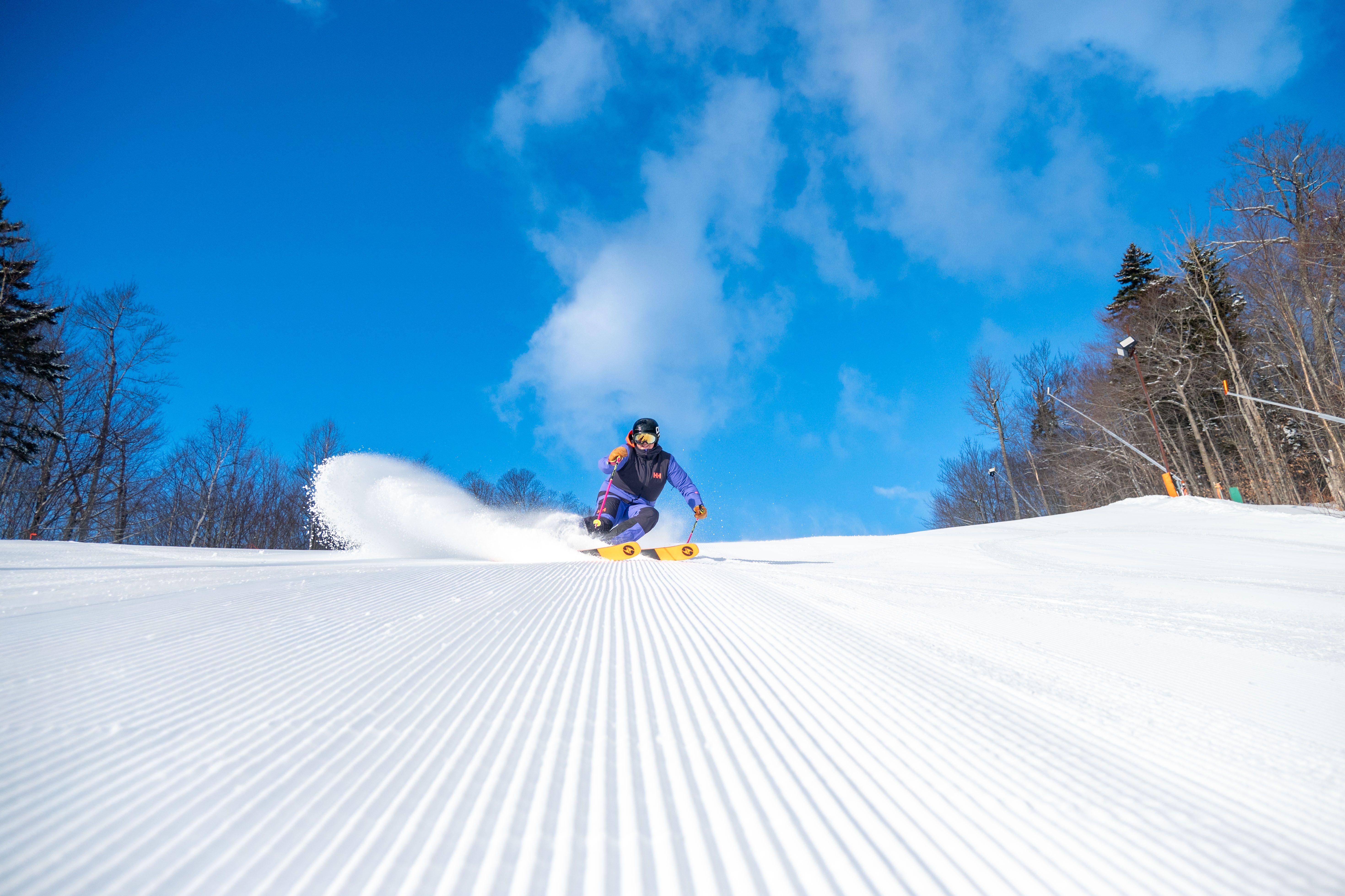 A woman skiing down a trail at Sunday River.