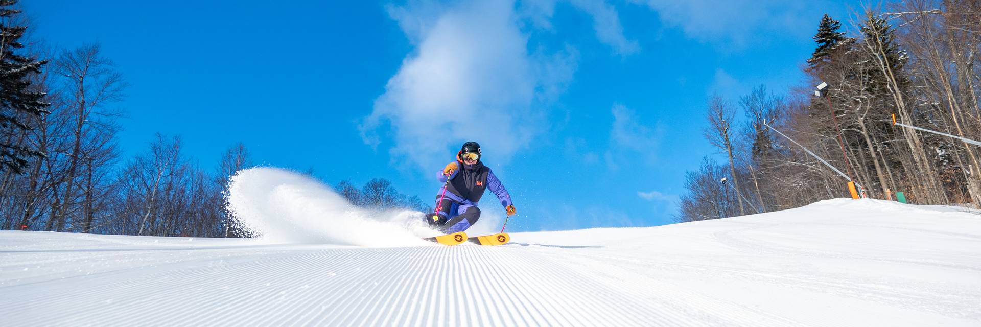 A woman skiing down a trail at Sunday River.