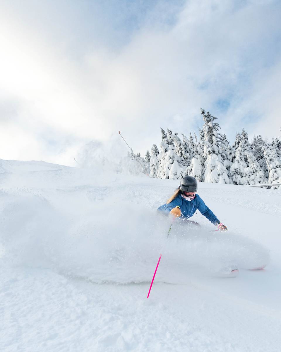 A person skiing in powder.