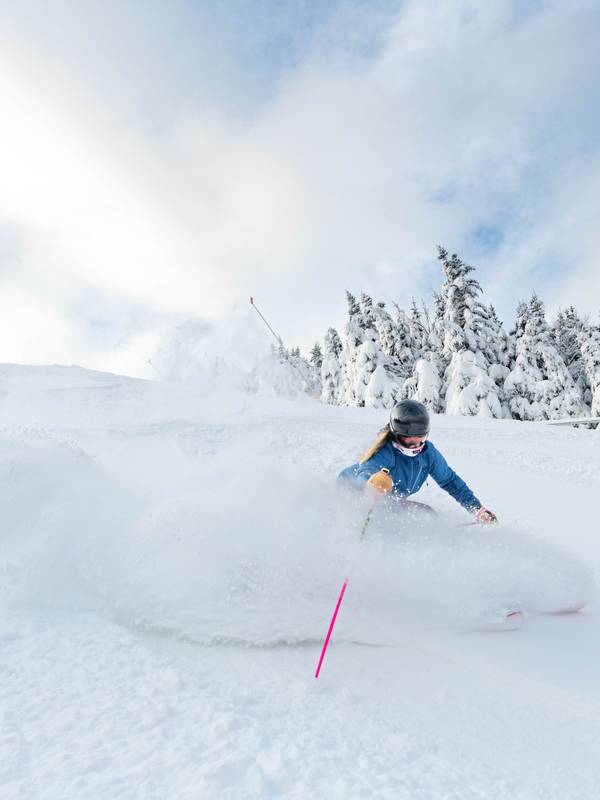 A skier in powder at Sunday River.