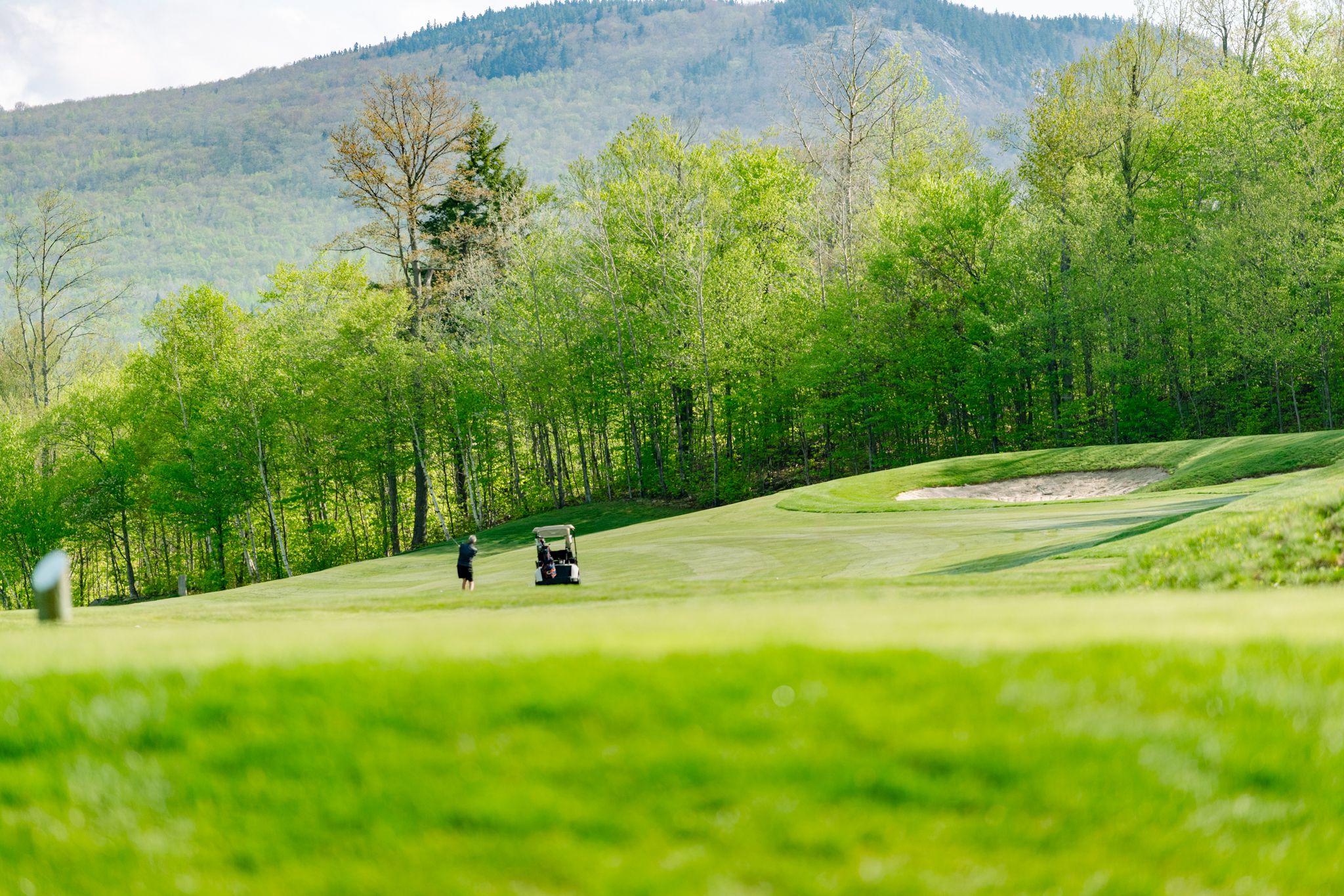 People playing golf in the summer at Sunday River Golf Club.