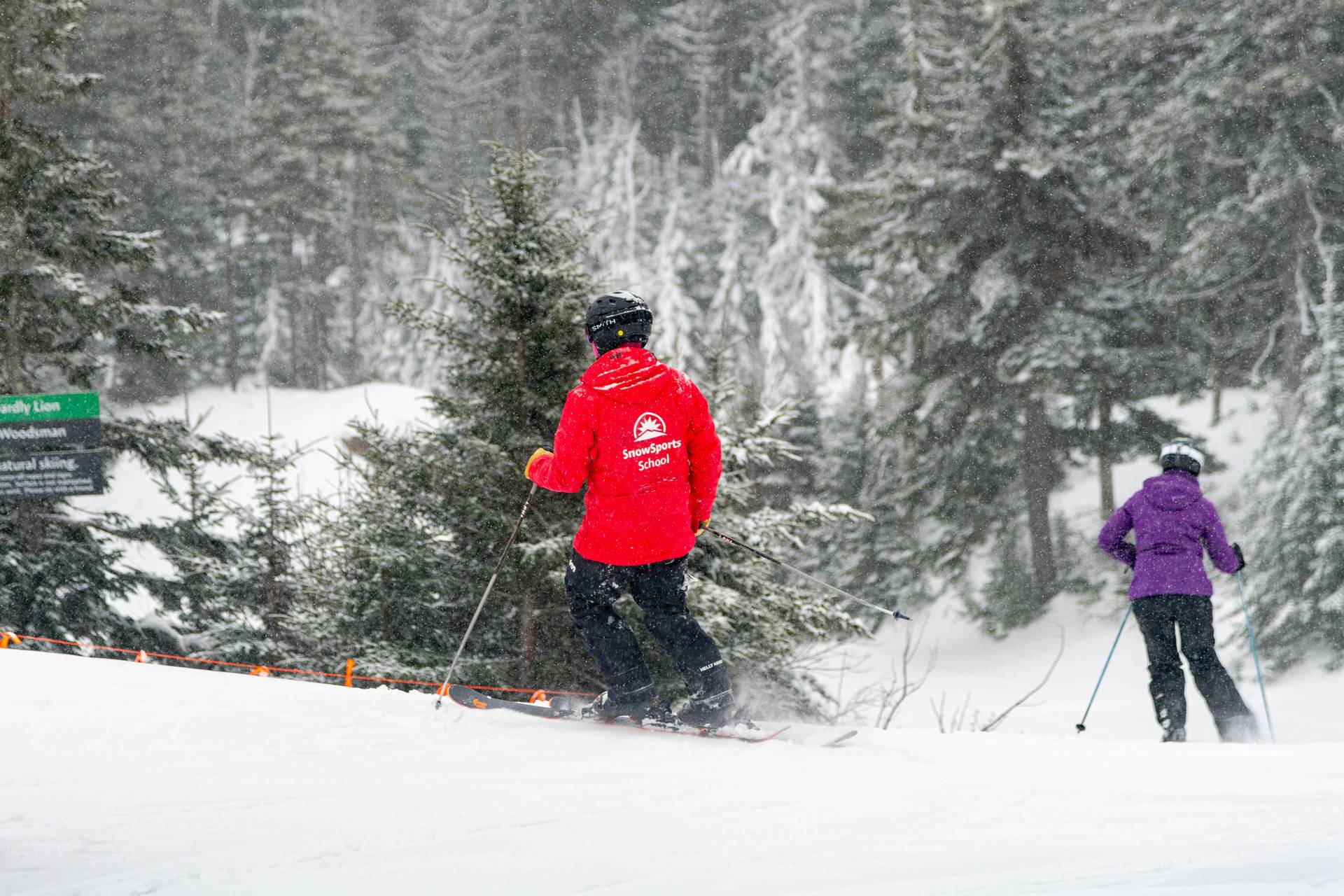 A woman skiing at Sunday River with their SnowSports instructor.