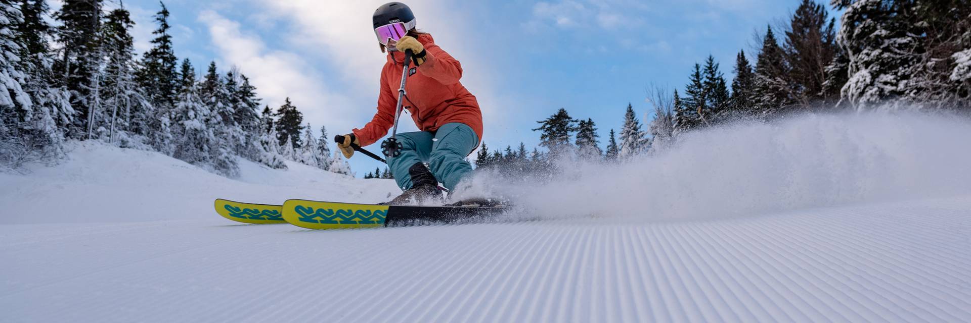 A skier shredding some fresh corduroy at Sunday River.