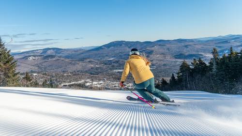 A woman skiing down a trail at Sunday River.