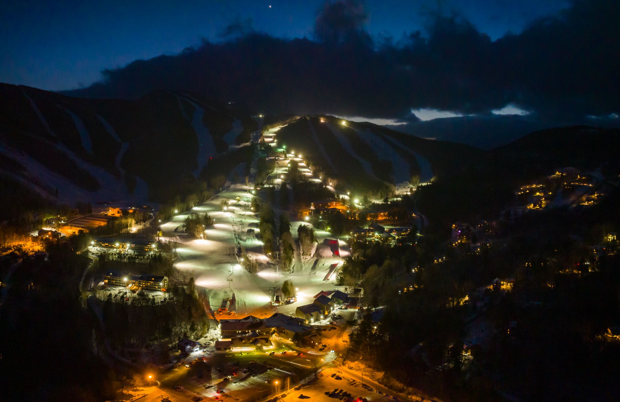 Twilight skiing trails with lights at Sunday River in the evening.