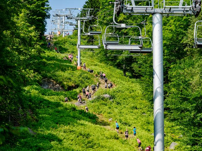 People climbing up a really steep hill at Sunday River's Tough Mountain Challenge.
