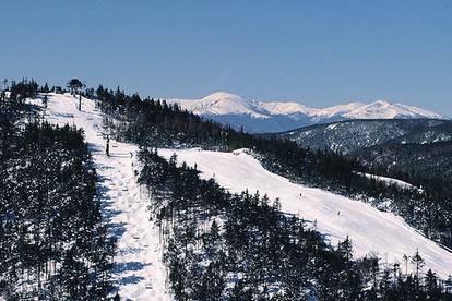 A drone view of some trails at Sunday River with the Presidential mountain range in the background.