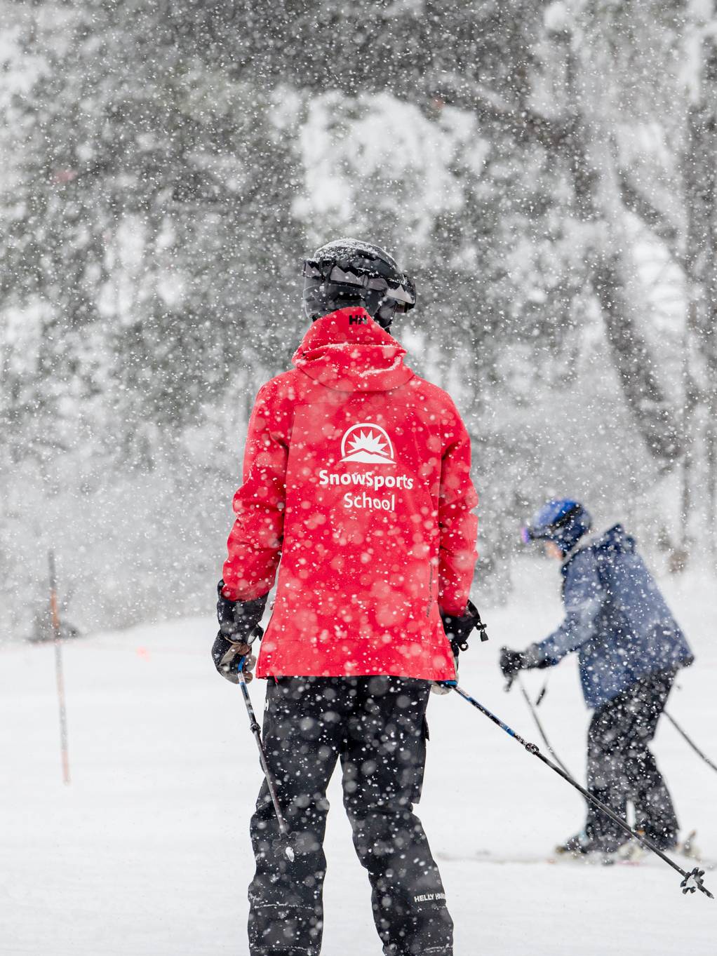 SnowSport School instructor teaching a lesson.