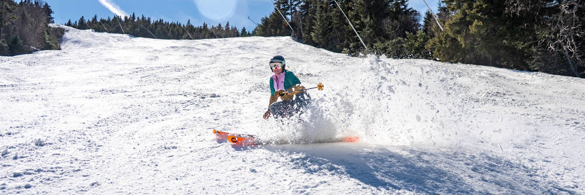 A person skiing in spring at Sunday River.